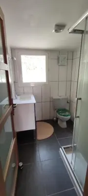 a small bathroom with a toilet and a window at le Jardin de Flore in Manosque