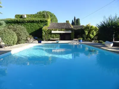 a large blue swimming pool with a gazebo at Mas D'Ange en Provence in Les Taillades