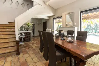 a dining room with a wooden table and chairs at Mas D'Ange en Provence in Les Taillades