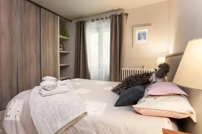 a bedroom with a bed with pillows and a lamp at Mas D'Ange en Provence in Les Taillades