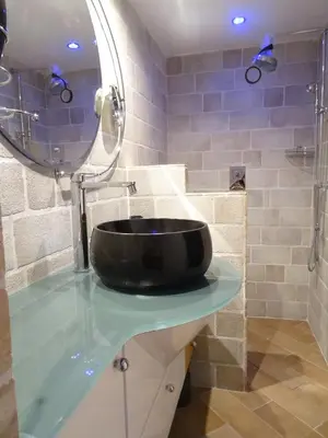 a bathroom with a black bowl sink on a counter at Mas D'Ange en Provence in Les Taillades