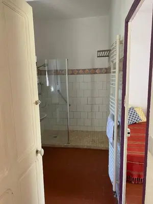 a bathroom with a shower with a glass door at Il était une fois à Lagnes in Lagnes