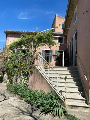 a house with a staircase leading to a building at Il était une fois à Lagnes in Lagnes