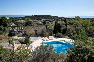 a swimming pool in front of a house at Le Fort de Bramafan in Caumont-sur-Durance