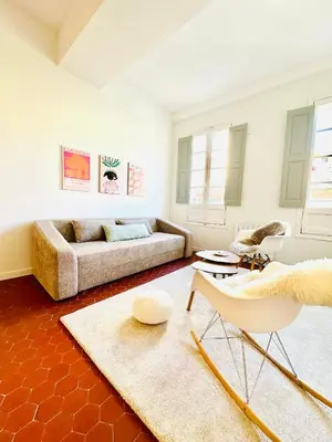a living room with a couch and a table at Design and Provençal Elegance Suite in Aix in Aix-en-Provence