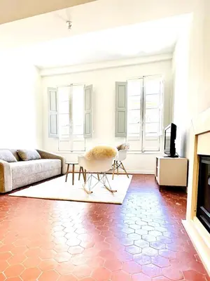 a living room with a couch and a table at Design and Provençal Elegance Suite in Aix in Aix-en-Provence