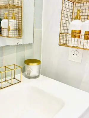 a bathroom with gold baskets and a sink at Design and Provençal Elegance Suite in Aix in Aix-en-Provence