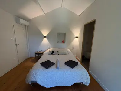 a bedroom with a large bed in a room at le mas au pied du Ventoux in Carpentras