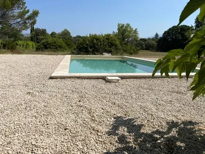 a small swimming pool in a gravel yard at le mas au pied du Ventoux in Carpentras