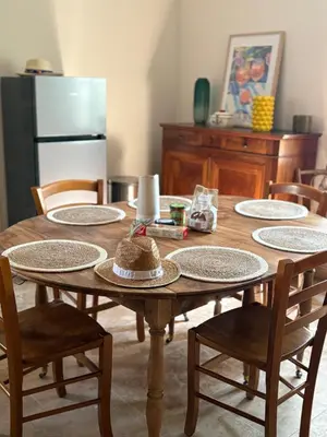 a wooden table with plates on it in a kitchen at le mas au pied du Ventoux in Carpentras