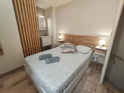 a small bedroom with a bed and a desk at Escapade dans le Luberon in Cavaillon