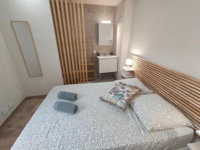 a bedroom with a bed with two blue towels on it at Escapade dans le Luberon in Cavaillon