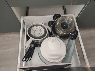 a cabinet with various kitchen utensils in it at Escapade dans le Luberon in Cavaillon