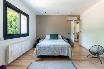 a bedroom with a bed and a window at Mas Provençal chic et élégant - Alpilles et Luberon in Sénas