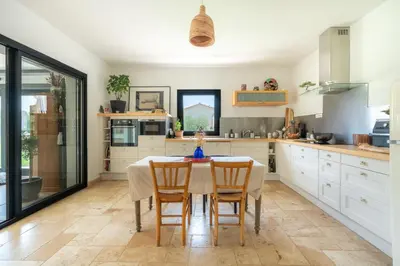 a kitchen with a table and chairs in it at Mas Provençal chic et élégant - Alpilles et Luberon in Sénas