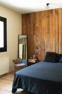 a bedroom with a bed and a mirror and a chair at Mas Provençal chic et élégant - Alpilles et Luberon in Sénas