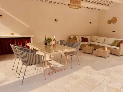 a living room with a table and chairs and a couch at Le Jas de la Cascade in Les Vignères