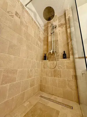 a shower with a glass door in a bathroom at Suite appartement in Châteaurenard