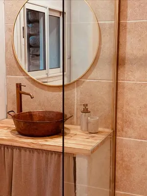 a bathroom with a wooden sink and a mirror at Le mazet du cavalier in Puyvert