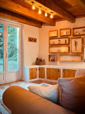 a living room with a couch and a window at Le mazet du cavalier in Puyvert