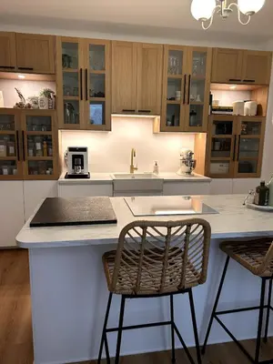 a kitchen with a white counter and two chairs at Villa de Seytres in Caumont-sur-Durance