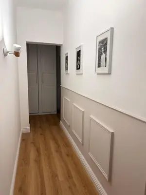 an empty hallway with white walls and wood floors at Villa de Seytres in Caumont-sur-Durance