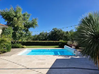 a swimming pool in a yard with a palm tree at La Canopée en Provence - Piscine, Vue sur le Mont Ventoux ! in Carpentras