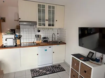 a kitchen with white cabinets and a counter top at studio calme campagne in Aix-en-Provence