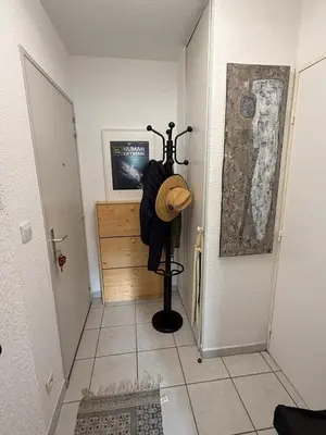 a hallway with a hat and an umbrella in a room at studio calme campagne in Aix-en-Provence