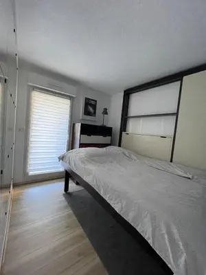 a bedroom with a large bed and a window at studio calme campagne in Aix-en-Provence
