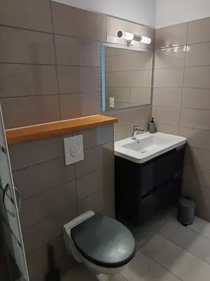 a bathroom with a sink and a toilet and a mirror at L'escale Cavaillonnaise in Cavaillon