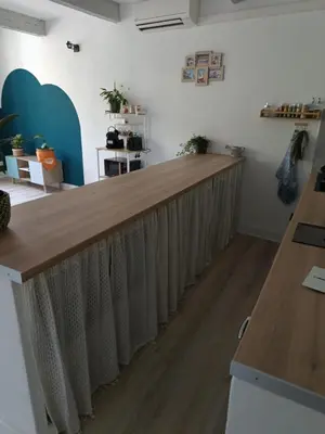 a bar in a room with a wooden counter at L'escale Cavaillonnaise in Cavaillon