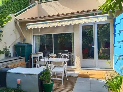 a patio with a table and chairs on it at Quiet ground floor, air conditioning, garden, 3 bedrooms, 7 people max in Salon-de-Provence