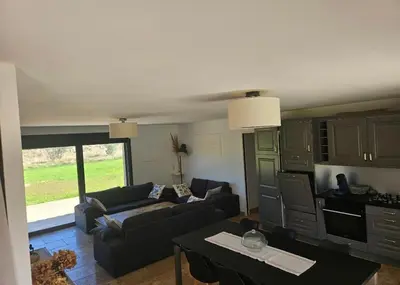 a living room with a couch and a table at Les oliviers in Saint-Didier