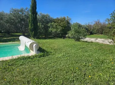 a slide in the middle of a grass field at Les oliviers in Saint-Didier