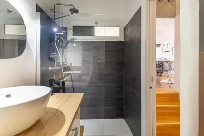 a bathroom with a white sink and a shower at Aixora - Centre historique - Tout à pied & parking in Aix-en-Provence