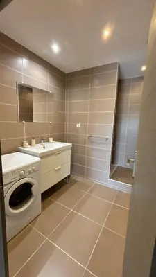 a bathroom with a washing machine and a sink at Petite maison à 2 pas du centre de Bédoin in Bédoin