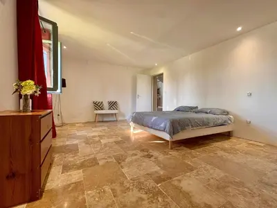 a bedroom with a bed and a dresser in it at Mas d Anissa in Avignon