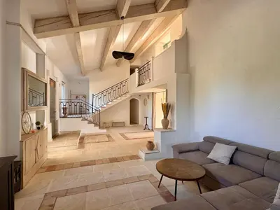 a living room with a couch and a table at Mas d Anissa in Avignon