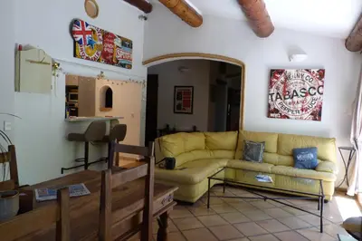 a living room with a yellow couch in a room at Villa Au Coeur Du Luberon in Maubec
