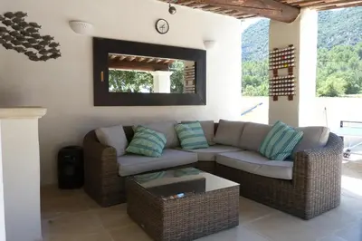 a living room with a couch and a table at Villa Au Coeur Du Luberon in Maubec