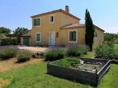 a house with a garden in front of it at Villa provençale piscine, calme et confort in Saint-Cannat