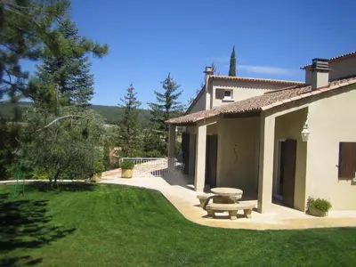 a house with a picnic bench in the yard at Attractive Holiday Home in C reste with Pool in Céreste