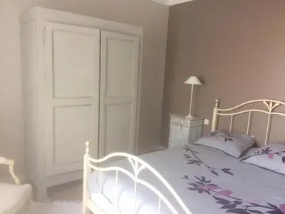 a bedroom with a white bed and a white door at Attractive Holiday Home in C reste with Pool in Céreste