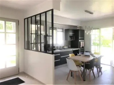 a kitchen and dining room with a table and chairs at Attractive Holiday Home in C reste with Pool in Céreste