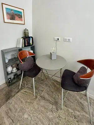 a room with a table and two chairs and a table at Très joli studio prôche Lourmarin in La Celle-sous-Gouzon