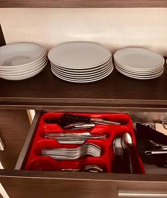 a drawer filled with plates and utensils at Duplex Cosy Aix proche CV terrasse clim parking in Aix-en-Provence