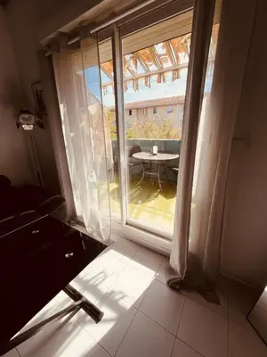 a room with a window with a table and a patio at Duplex Cosy Aix proche CV terrasse clim parking in Aix-en-Provence