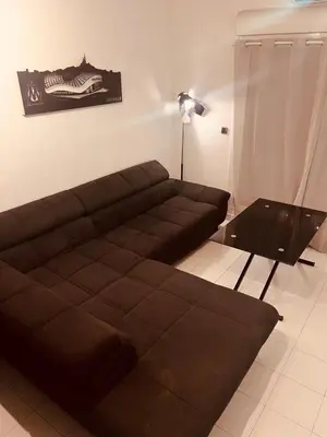 a living room with a brown couch and a table at Duplex Cosy Aix proche CV terrasse clim parking in Aix-en-Provence