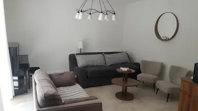 a living room with a couch and a mirror at Fully renovated Provençal farmhouse in Châteauneuf-de-Gadagne
